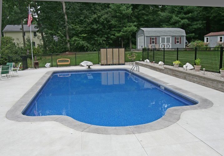 This is a photo of a patrician in ground pool in Saugerties, NY diving board and fence in backyard.
