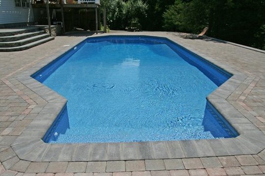 This is a photo of a grecian style inground swimming pool.